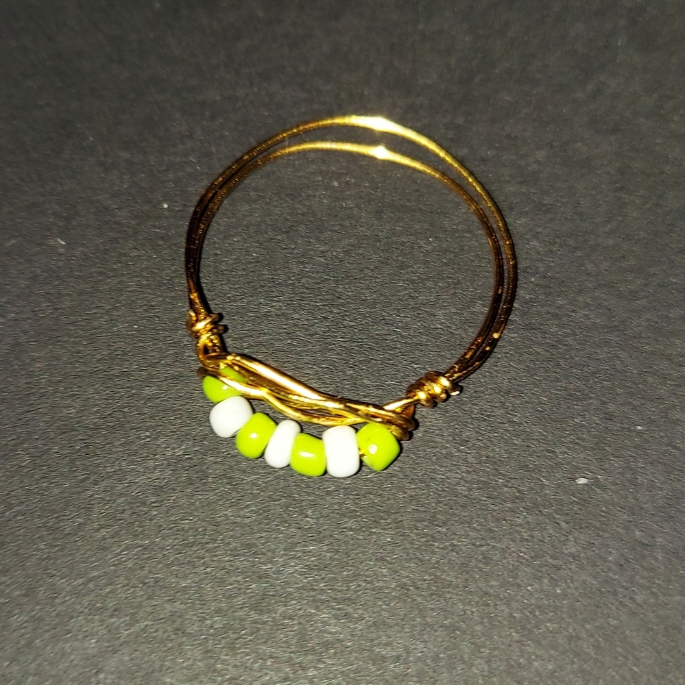 green, white, and gold ring.